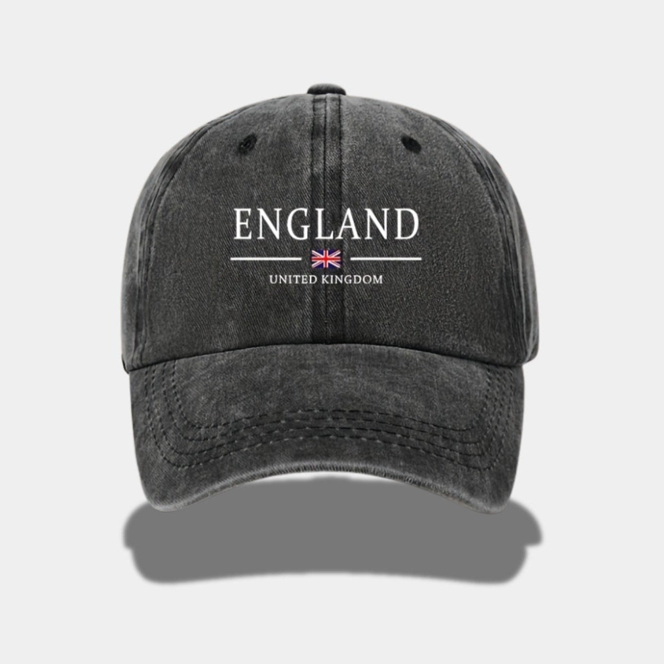 Black cap with 'England United Kingdom' text and British flag on a white background